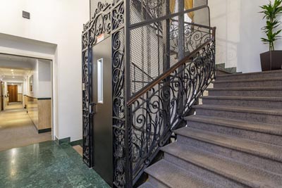 Corridor on the floor with the wrought iron elevator